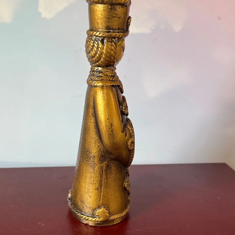 vintage chalkware candle holder featuring a metallic gold-finished figure